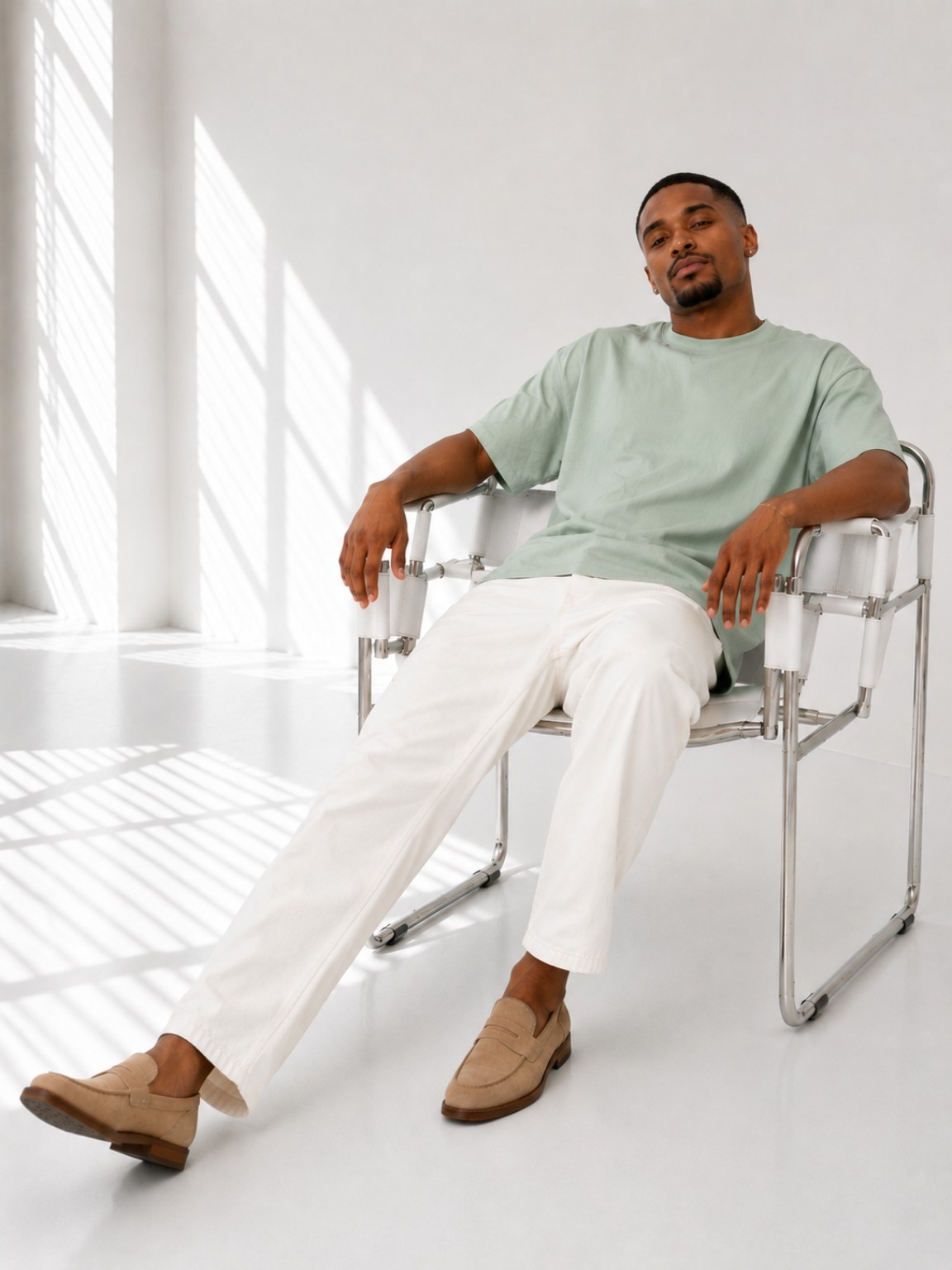 Male model seated in a Laurel Green Luxe Plain T-Shirt